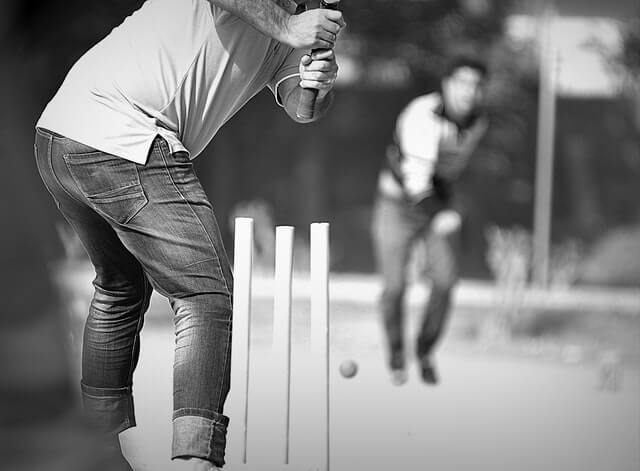 Man hitting a ball with a cricket bat