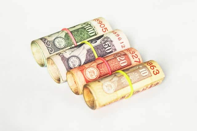 Roll of Rupees on a White Background