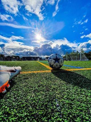 football shoe and ball on grass